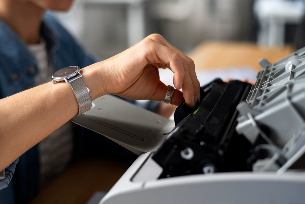 Technician repairing an office printer